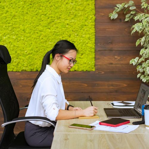Person sitting calmly in a modern office environment